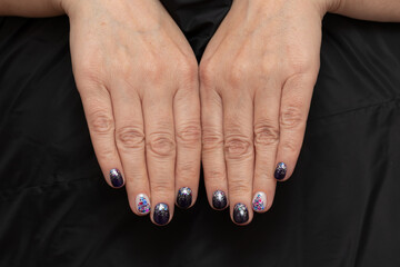 New Year's manicure on short nails, dark blue gel polish, decorated with sequins and Christmas tree