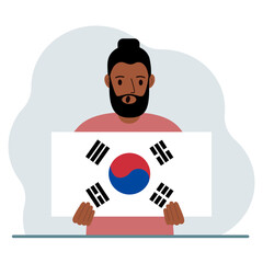 A man is holding the flag of South Korea. The concept of demonstration, national holiday, independence day or patriotism. Nationality.