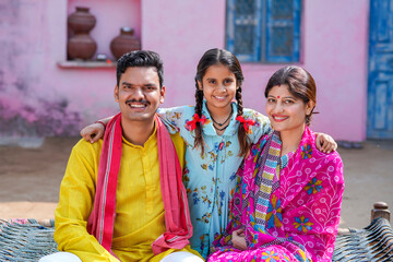 Happy indian farmer couple with Daughter.