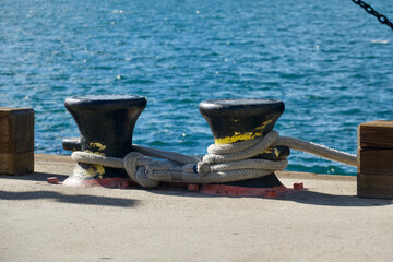 heavy metal bollards await the next cruise ship to arrive in the harbor