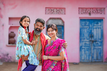 Fototapeta na wymiar Happy indian farmer couple with daughter
