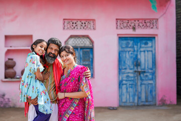 Fototapeta na wymiar Happy indian farmer couple with daughter