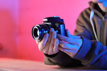 digital slr camera with an old lens in the hands of a person