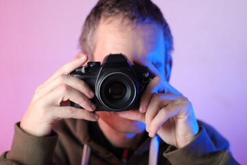digital slr camera with an old lens in the hands of a person