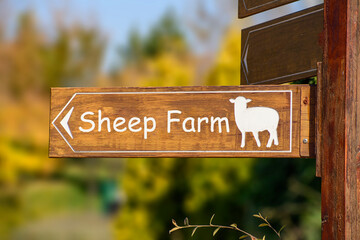 wooden sign showing the location of the sheep farm