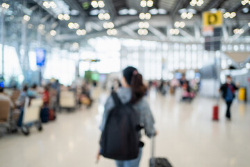 Blurred image of happy Asian woman with backpack and luggage standing on at international airport. Background image.