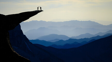 Successful duo on the summits of fascinating, mystical and impressive mountains - obrazy, fototapety, plakaty
