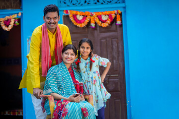 Fototapeta na wymiar Happy indian farmer couple with his little girl.