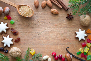 Christmas cookies, nuts and aromatic spices on wooden background, christmas food concept, free space 