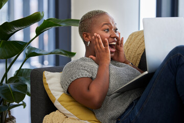Laptop, surprise and excited black woman on sofa shocked with win of digital lottery, competition...