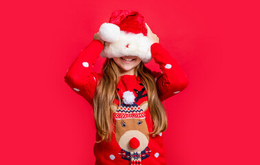 teen girl wearing sweater and santa hat at christmas holiday. merry christmas. funny teen girl