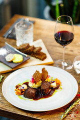 Deer tenderloin. Truffle-potato puree, porcini mushrooms, baked leek and carrot, juniper bread, port wine sauce. Delicious healthy traditional food served for lunch in modern gourmet restaurant