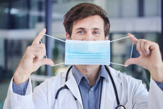 Healthcare, Face Mask And Portrait Of Doctor In A Hospital Standing In The Lobby After A Consultation. Covid Regulations, Pandemic And Surgeon With Mask Working In Medicare Clinic Or Center In Canada