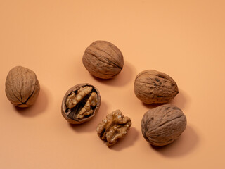 Walnut on an orange background. Raw walnut.