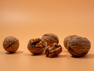 Walnut on an orange background. Raw walnut.