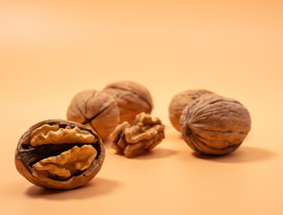 Walnut on an orange background. Raw walnut.