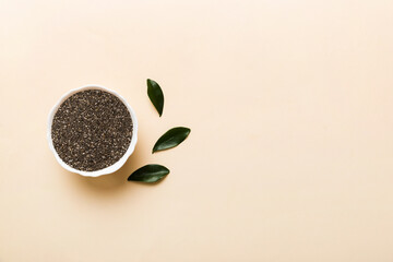 Chia seeds in bowl on colored background. Healthy Salvia hispanica in small bowl. Healthy superfood