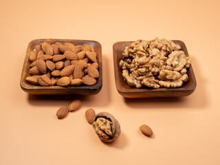 Various nuts on an orange background. Mixed nuts.