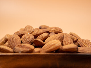 Almond nut on an orange background. Raw almond.