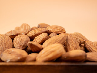 Almond nut on an orange background. Raw almond.