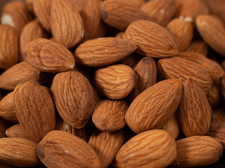 Almond nut on an orange background. Raw almond.