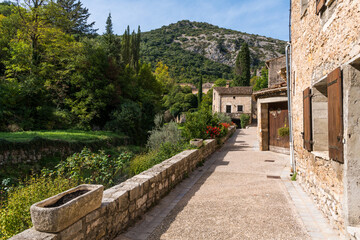 Fototapeta na wymiar Walkway and landscape at the edge of the historic French village of Saint-Guilhem-le-Desert