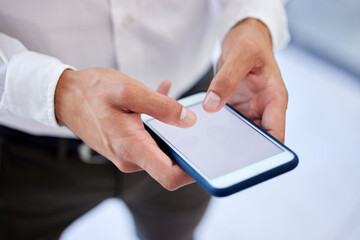 Phone screen, mockup space or social media while typing hands of a businessman in a office. Zoom hand of worker browsing, send text or sms message or emails while at work with mock up advertising