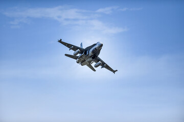 Fototapeta na wymiar Military supersonic fighter jet with blue sky in the background