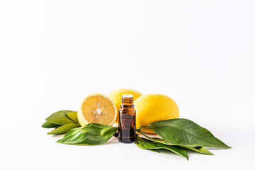 lemon essential oil in a medical bottle with a dropper on a white background with lemons. A blank...