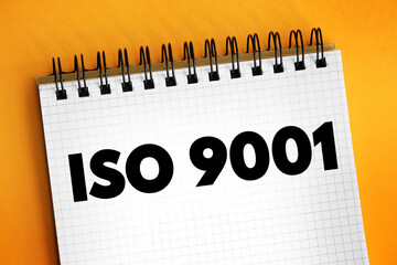 ISO 9001 - international standard that specifies requirements for a quality management system, text concept on notepad - obrazy, fototapety, plakaty