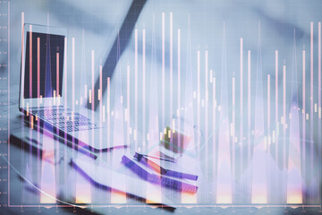 Forex Chart hologram on table with computer background. Multi exposure. Concept of financial markets.