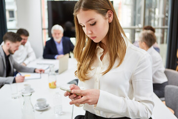 Fototapeta premium Trainee reads SMS or checks news on smartphone