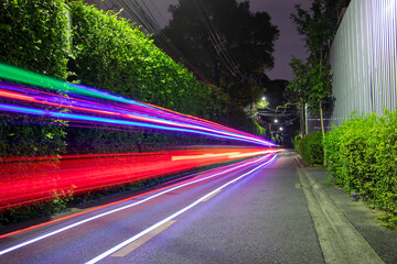  colorful car traffic on a city street at night