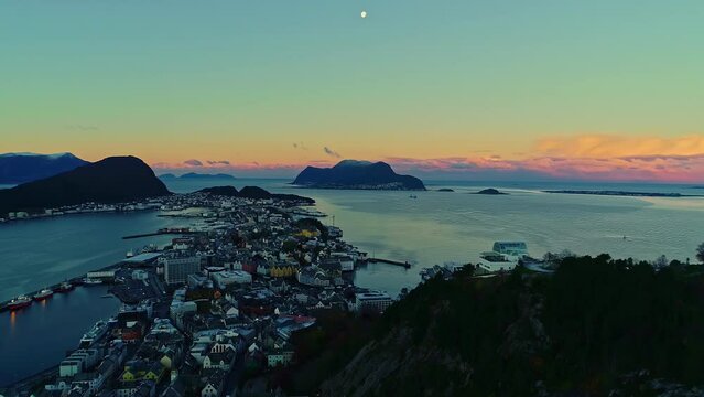 Iconic Scandinavian coastal town with sunset sky glow, aerial view