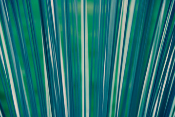 Abstract glass background close up. Texture of wavy glass illuminated with multi-colored light....