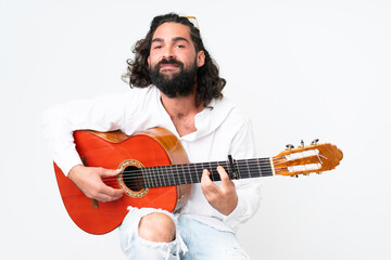 Obraz premium Young man with beard playing guitar on white background