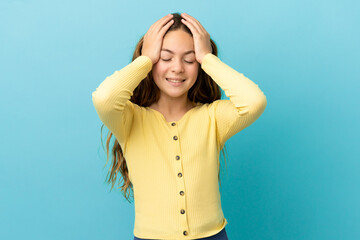 Little caucasian girl isolated on blue background laughing