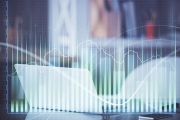 Forex Chart hologram on table with computer background. Multi exposure. Concept of financial...
