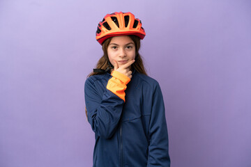Little caucasian girl isolated on purple background thinking