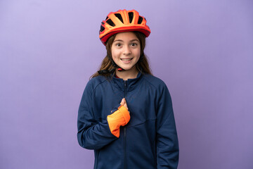 Little caucasian girl isolated on purple background with surprise facial expression