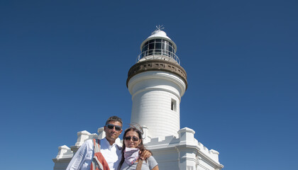 Couple of caucasian people visiting Byron Bay lighthouse, Australia