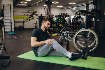 Fototapeta na wymiar Person who uses a wheelchair training in the gym. Rehabilitation center