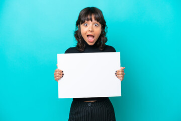 Young latin woman isolated on blue background holding an empty placard with happy expression