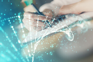 DNA theme hologram over woman's hands writing background. Concept of education. Double exposure
