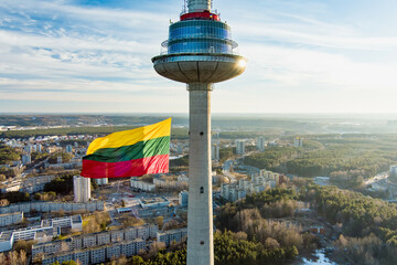 Giant tricolor Lithuanian flag waving on Vilnius television tower on the celebration of Restoration...