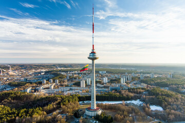 Obraz premium Giant tricolor Lithuanian flag waving on Vilnius television tower on the celebration of Restoration of the State Day.