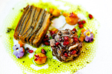 Shiitake and potatoes (vegan). Shiitake mushroom, potato gratin, Beluga lentils, yellow beet cream. Delicious healthy traditional food closeup served for lunch in modern gourmet cuisine restaurant