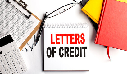 LETTER OF CREDIT text on notebook with clipboard and calculator on white background