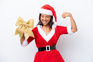 Young hispanic woman dressed as mama noel holding a Christmas bow isolated on white background doing strong gesture