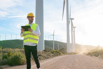 Engineer checking wind turbine energy with a tablet